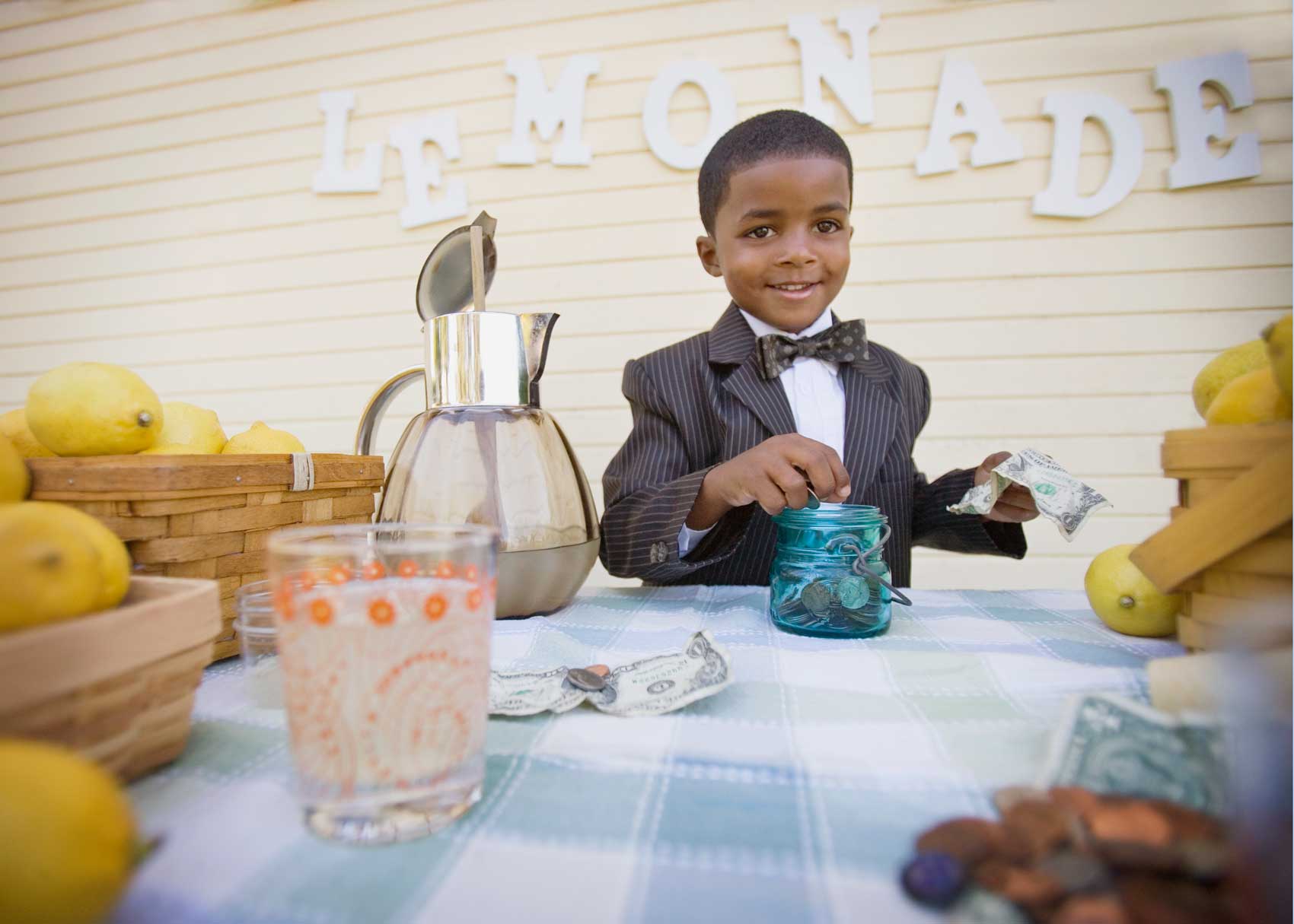 Young entrepreneur operating a lemonade stand